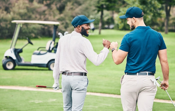 Two golfers celebrating on the course